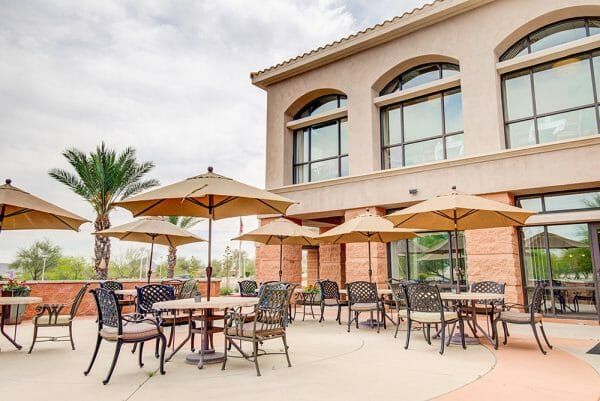 Fountain View Village community patio with many umbrella tables for residents to sit