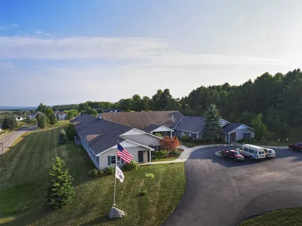 American House Petoskey exterior aerial view with trees and community in the background