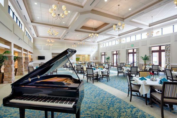 Black grand piano in the The Fountains of Hope community dining room