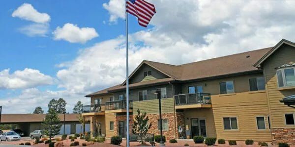 Majestic Rim Retirement Living building exterior wth American flag pole in front