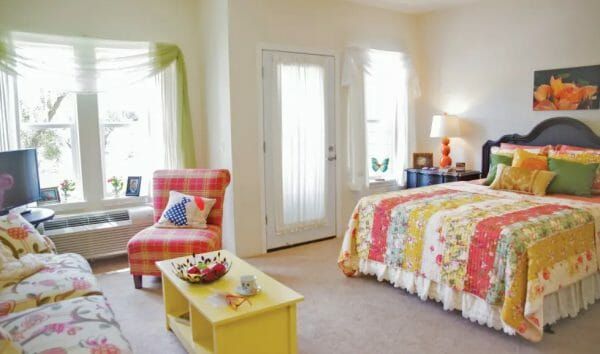 Model residence interior with a colorful bedspread in Summit Glen