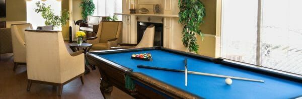 Blue felt pool table in the Marycrest Assisted Living billiards room