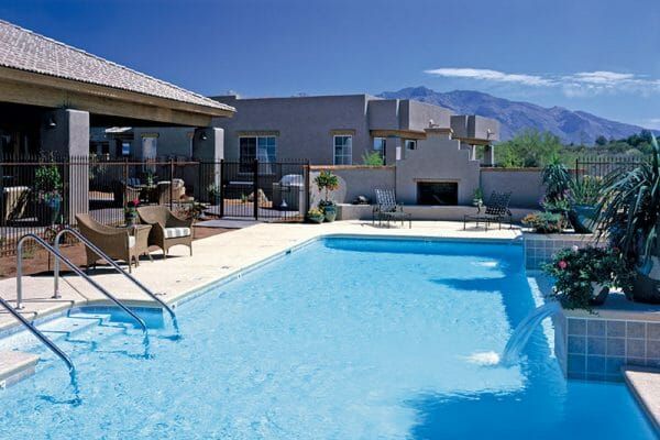 Outdoor swimming pool and fireplace at The Fountains at La Cholla