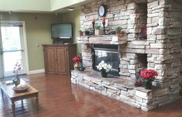 Stone fireplace in the Palm Gardens Assisted Living community living room