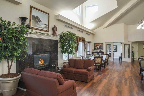 Sofas on either side of a fireplace in the Truewood by Merrill, Roseville community living room