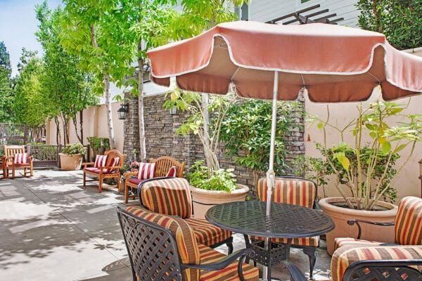 Patio with Outdoor Tables and Umbrellas at Sunrise of Studio City