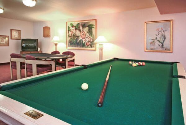 Green felt pool table in The Remington billiards room