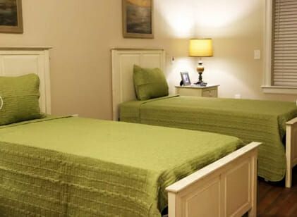 Two twin beds in a Carteret Landing Assisted Living model home