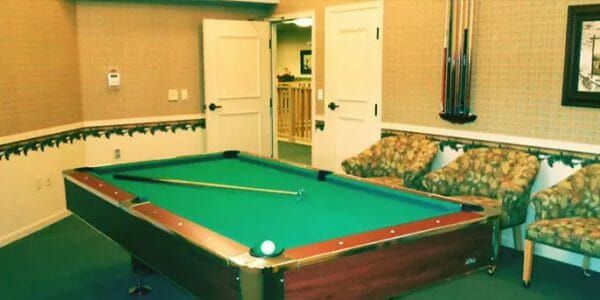 Green felt pool table in the Majestic Rim Retirement Living billiards room