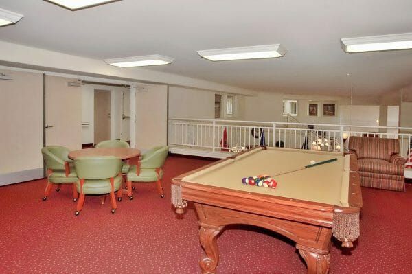 Tan felt pool table and poker table in the Highland Trail game room