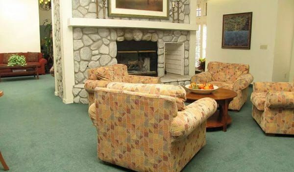Chairs in front of the fireplace in the Hilltop Commons community living room
