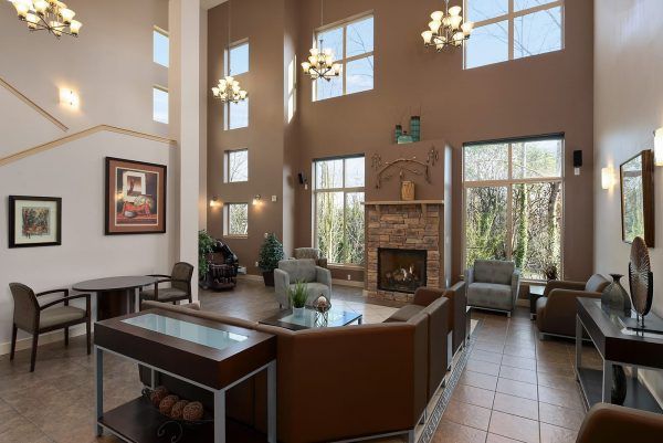 The two-story community living room at Arrowhead Gardens, with a fireplace and multiple sitting areas