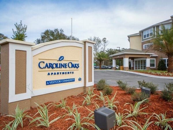 Entrance and sign at Caroline Oaks Apartments