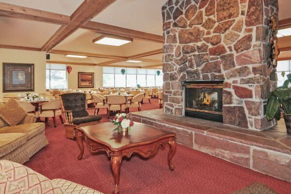 Large stone fireplace and social gathering spot in the living area of The Courtyard at Lakewood