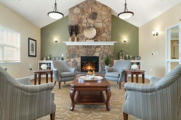 Roaring fire behind sitting chairs in the TerraBella Lake Norman community living room