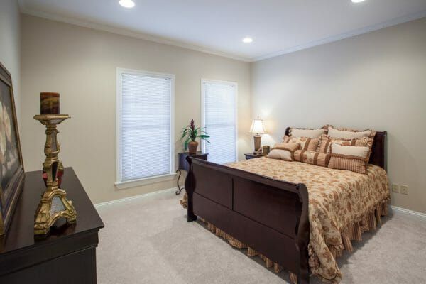 Model bedroom in a The Brennity at Fairhope independent living cottage home