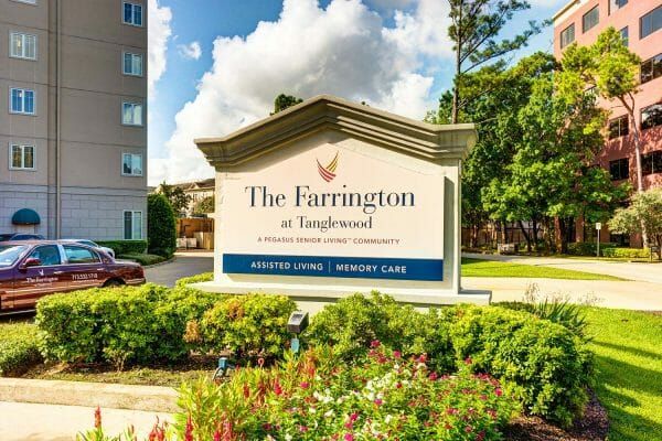 Welcome sign and colorful landscaping in front of The Farrington at Tanglewood