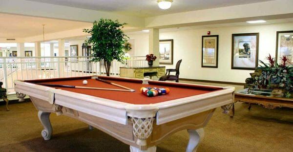 Red felt pool table in the Solstice Senior Living at Fenton billiards room