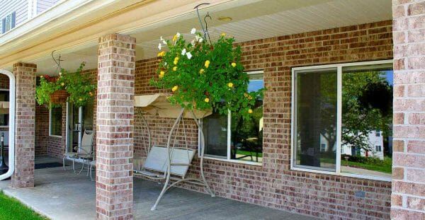 Hanging plany and outdoor seating on the Solstice Senior Living at Fenton porch
