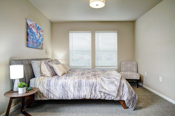 The bedroom of a model apartment at GenCare Lifestyle Federal Way