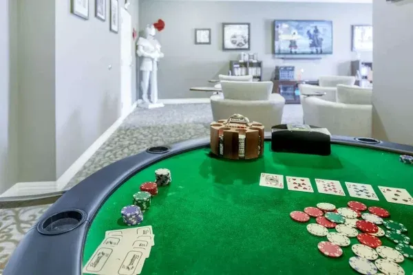 The Trace game room with poker table with cards and chips