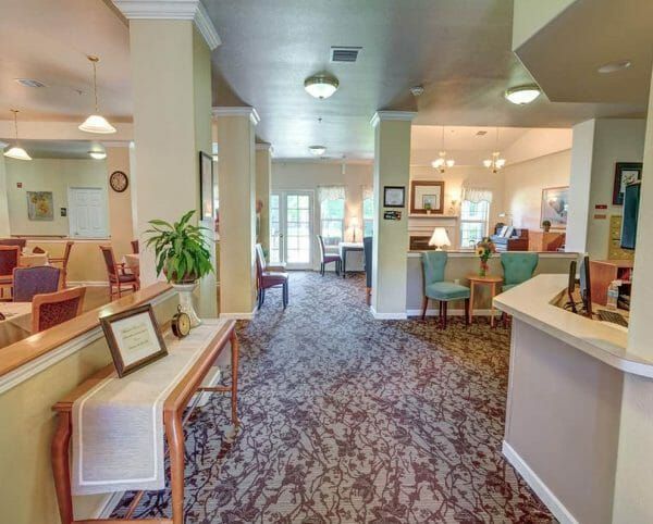 Entry way with organ in background, reception area to the right with a computer glass double doors in front at Mountain View Assisted Living and Memory Care