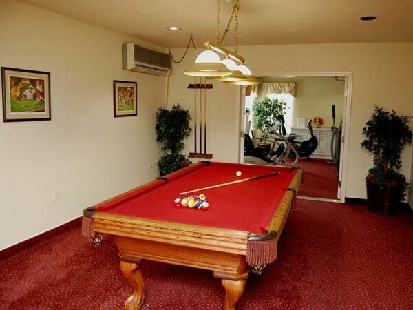Red felt pool table in the Lodge at Cold Spring billiards room