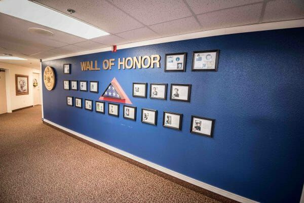 Wall of military honor photos in Solstice Senior Living at Lodi