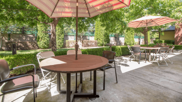 Umbrella tables and chairs on the Somerford Place Roseville patio