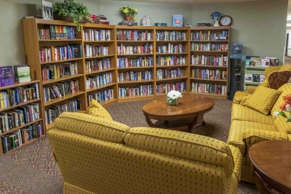 Library with loveseats and coffee table at The Oakmont