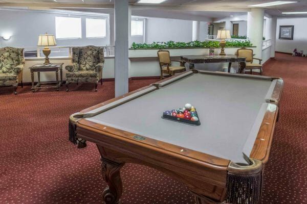 Gray felt pool table in the Walnut Park billiards room