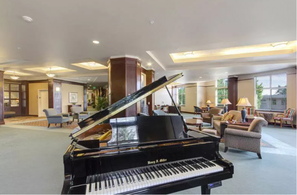 A grand piano in the common area at Merrill Gardens at Tacoma