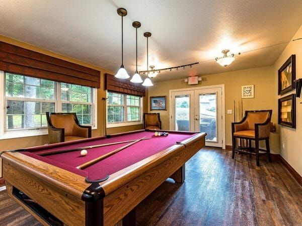 Billiards room at Pacifica Senior Living Heritage Hills with red covered pool table