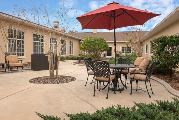 Umbrella tables in the courtyard of Life Care Center of New Port Richey