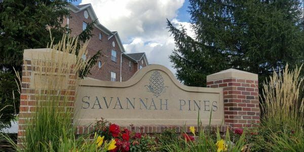 Sign at the community entrance of Savannah Pines Retirement