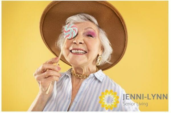 Smiling-Lady-with-lollipop-covering-right-eye-with-Jenni-Lynn-Logo