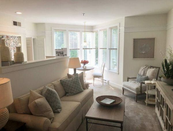 Living room with large bright windows in a Solstice Senior Living at Guilford model home