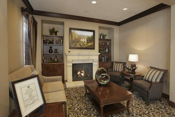 Sunol Creek Memory Care community den with cozy fireplace