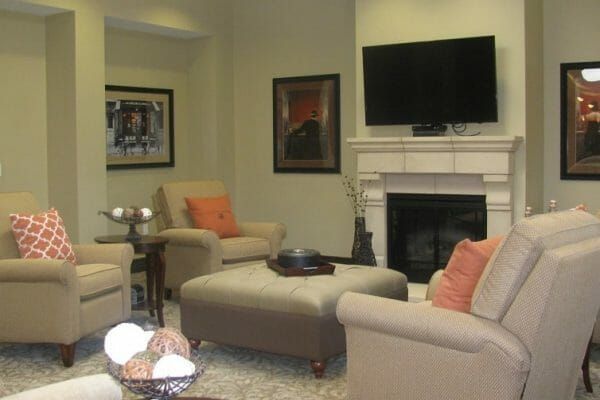 Community living room with fireplace in Sunol Creek Memory Care