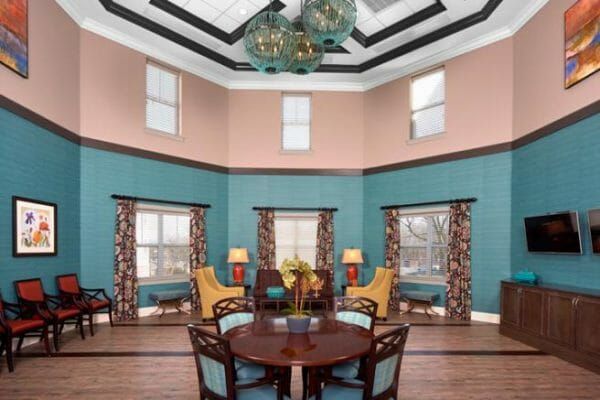 The Bristal Assisted Living Lake Grove common area with vaulted ceiling and many seating options