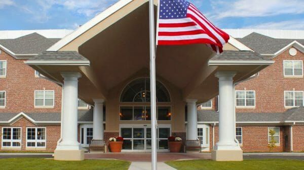 Towne Center Retirement covered entrance and American flag