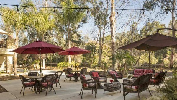 Red umbrella patio dining tables in the Atria Del Sol courtyard