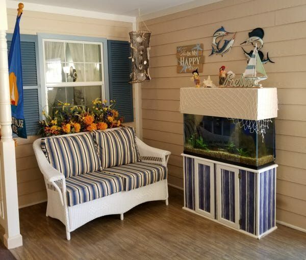 Seating area with large fishtank on the porch at Arden Courts at Tampa