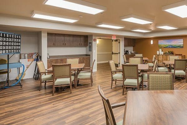 Activity room with 4 top tables and chairs at Brookdale Central Paradise Valley