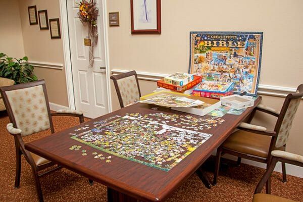 Working puzzle on a table in the Brookdale Henderson game room