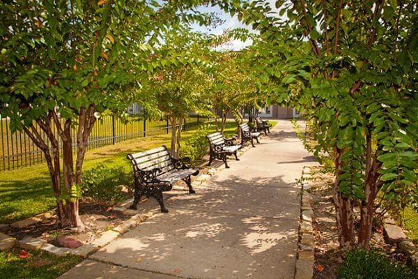 Walking paths and park benches on the Brookdale Henderson patio