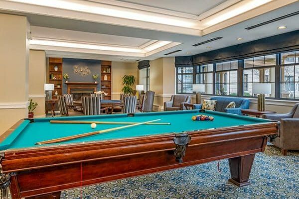 Green felt pool table in the Brookdale Lisle billiards and game room