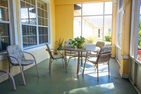 Table and chairs on the Brookdale Punta Gorda Isles indoor patio