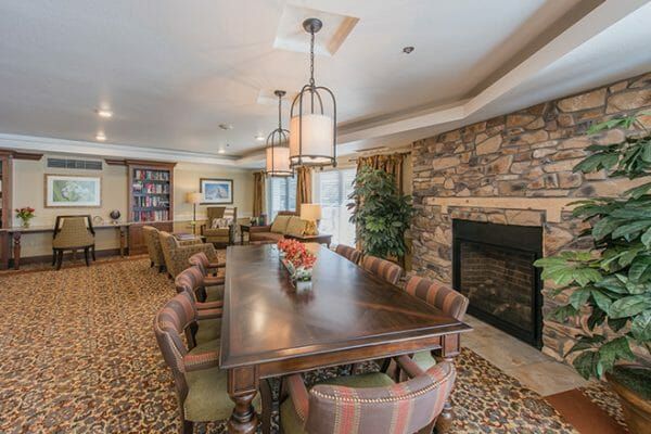 Brookdale Skyline library with long conference table and stone fireplace