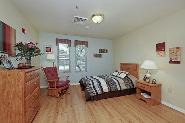 Brookdale Tempe model bedroom with a double bed and glider chair